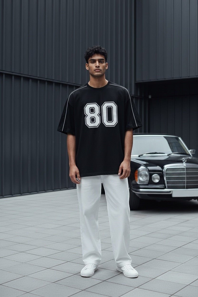 Koti Apparels black graphic baseball jersey t-shirt with white '80' graphic and piping on shoulders and sleeves.