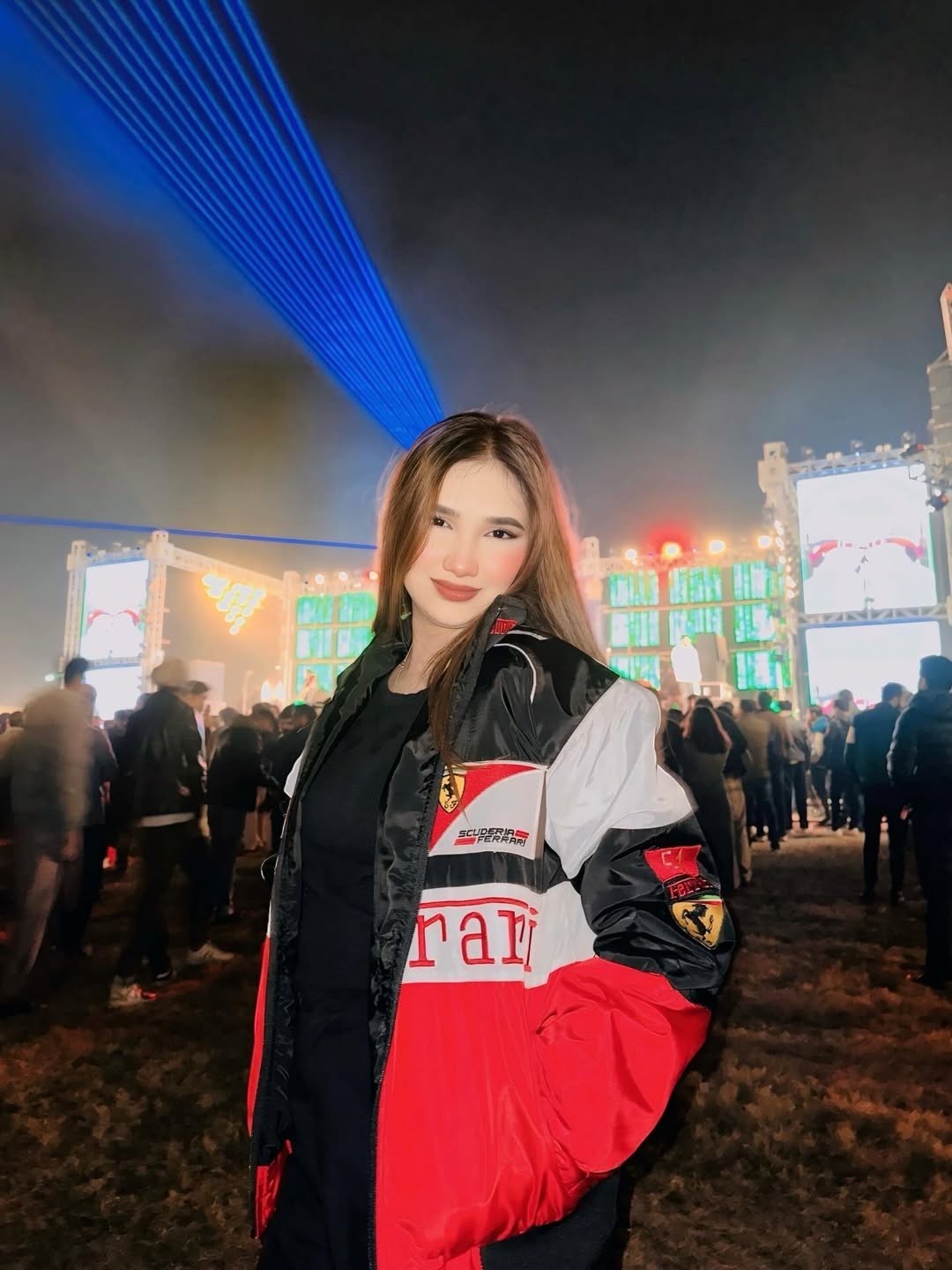 Koti Apparels Formula 1 Ferrari racing jacket in red, white, and black with embroidered logos. Worn by a woman at an outdoor event.