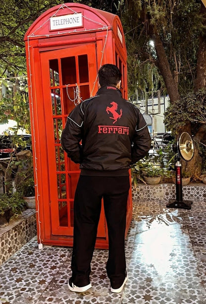 Koti Apparels black polyester Formula 1 Ferrari racing jacket with red embroidered logo and white piping.