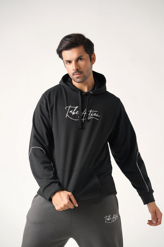 Man wearing a black hoodie with 'Take Action' text on a white background