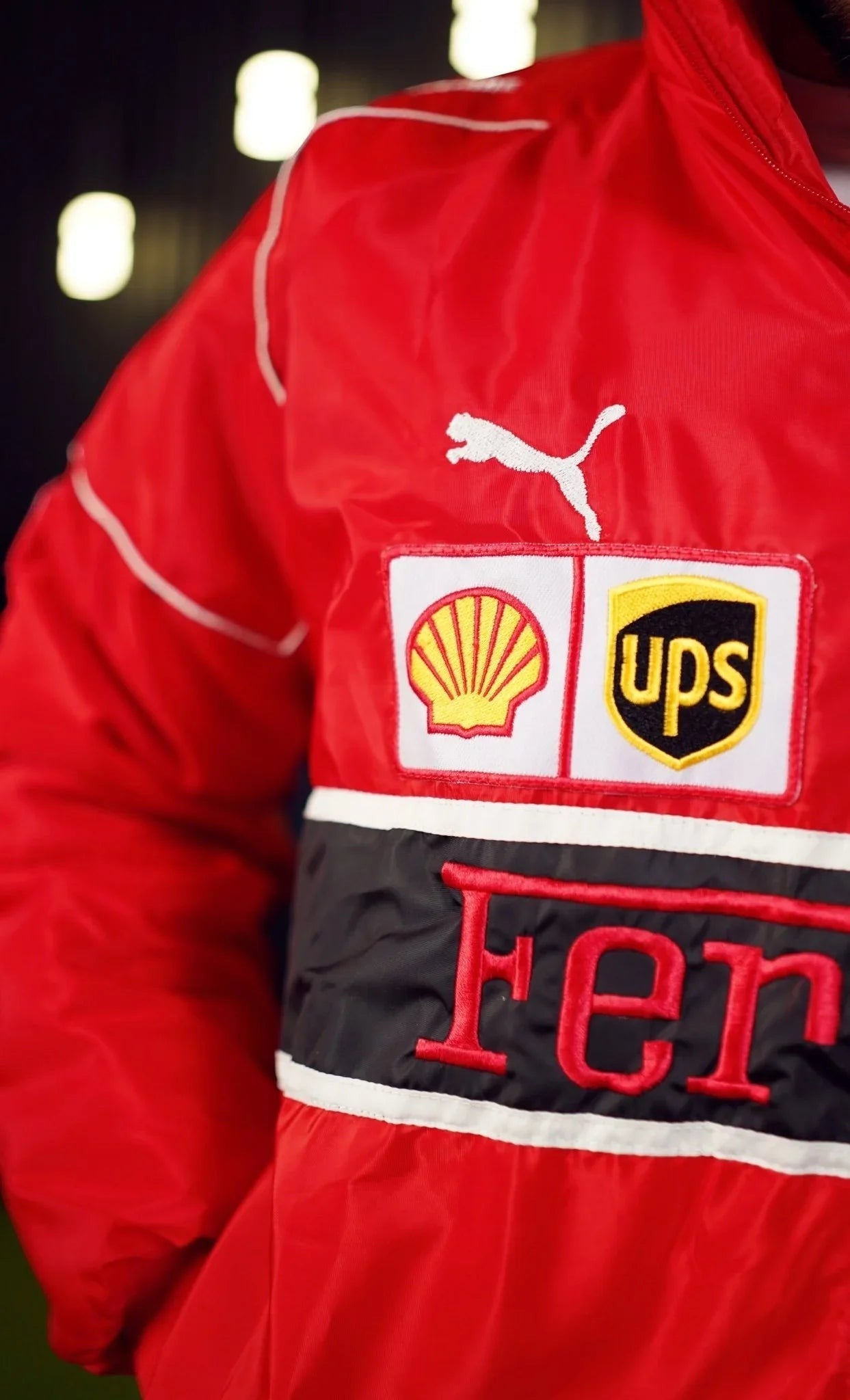 Koti Apparels red polyester Formula 1 Ferrari racing jacket with embroidered logos and white trim.