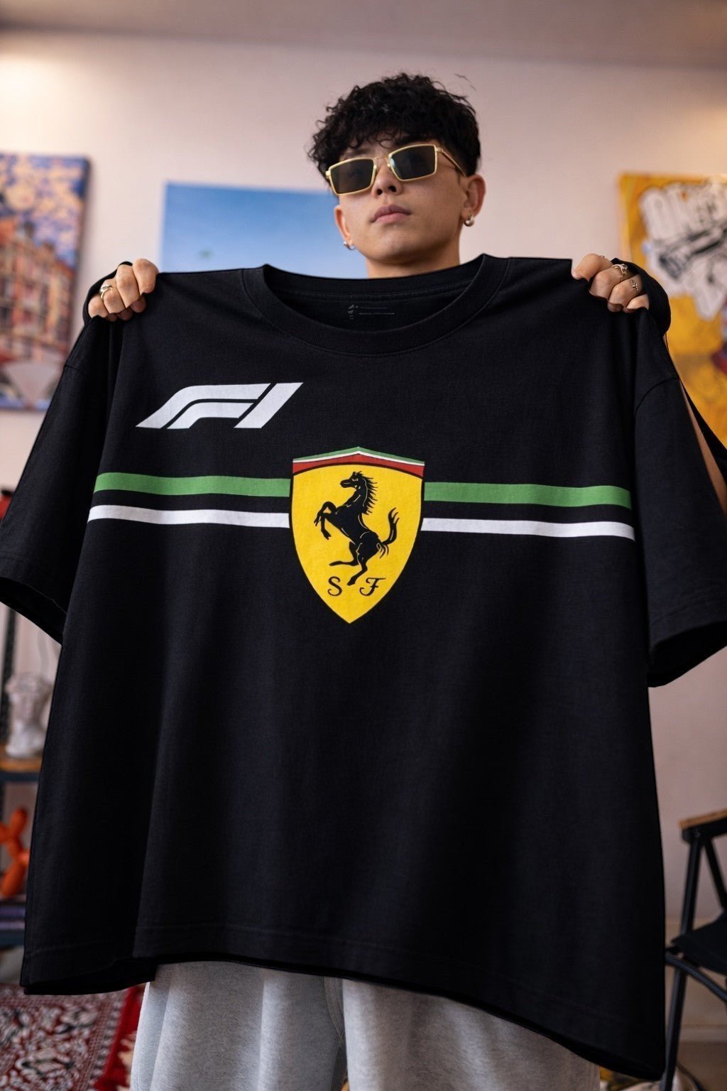 Koti Apparels black cotton Formula 1 t-shirt with Ferrari Prancing Horse logo and green/white stripe detail.
