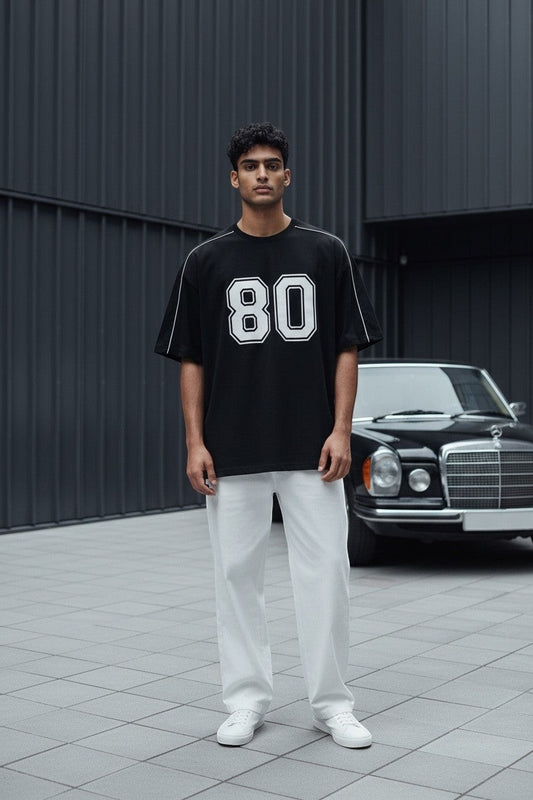 Koti Apparels black graphic baseball jersey t-shirt with white '80' graphic and piping on shoulders and sleeves.