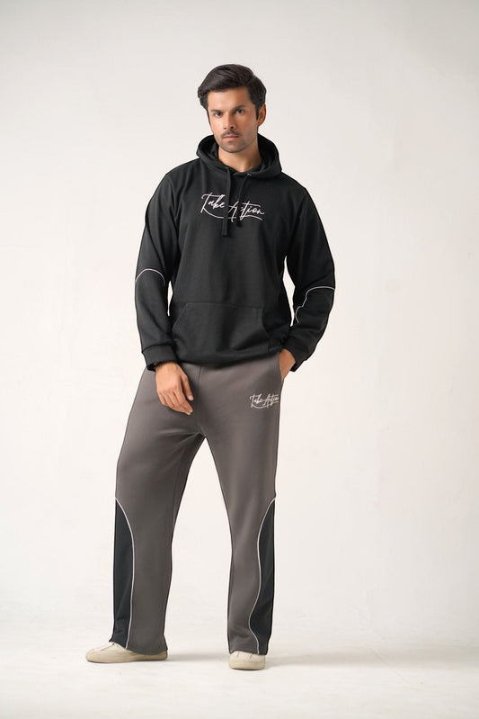 Koti Apparels black heavyweight cotton fleece hoodie with white embroidered logo and grey trousers with black and white panel details.