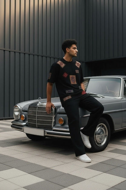 Koti Apparels black cotton t-shirt with colorful oriental rug patches on the chest and sleeves.