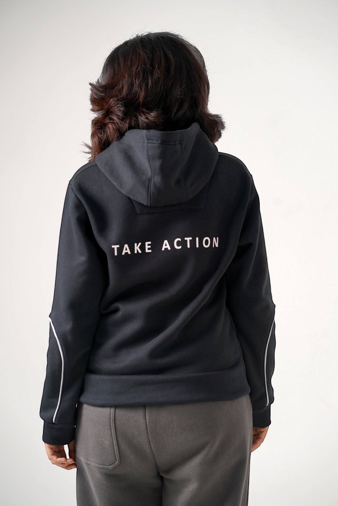 Koti Apparels black heavyweight cotton fleece unisex hoodie with "TAKE ACTION" text on back and matching grey trousers.
