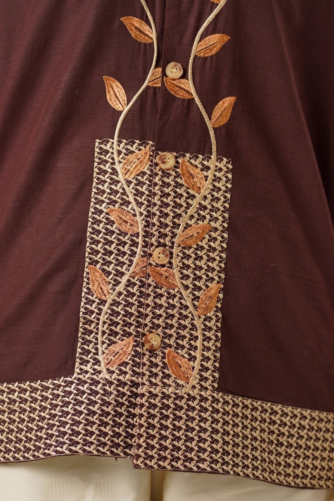 Koti Apparels unisex brown khaddar shirt with intricate leaf embroidery on the placket and cuffs.