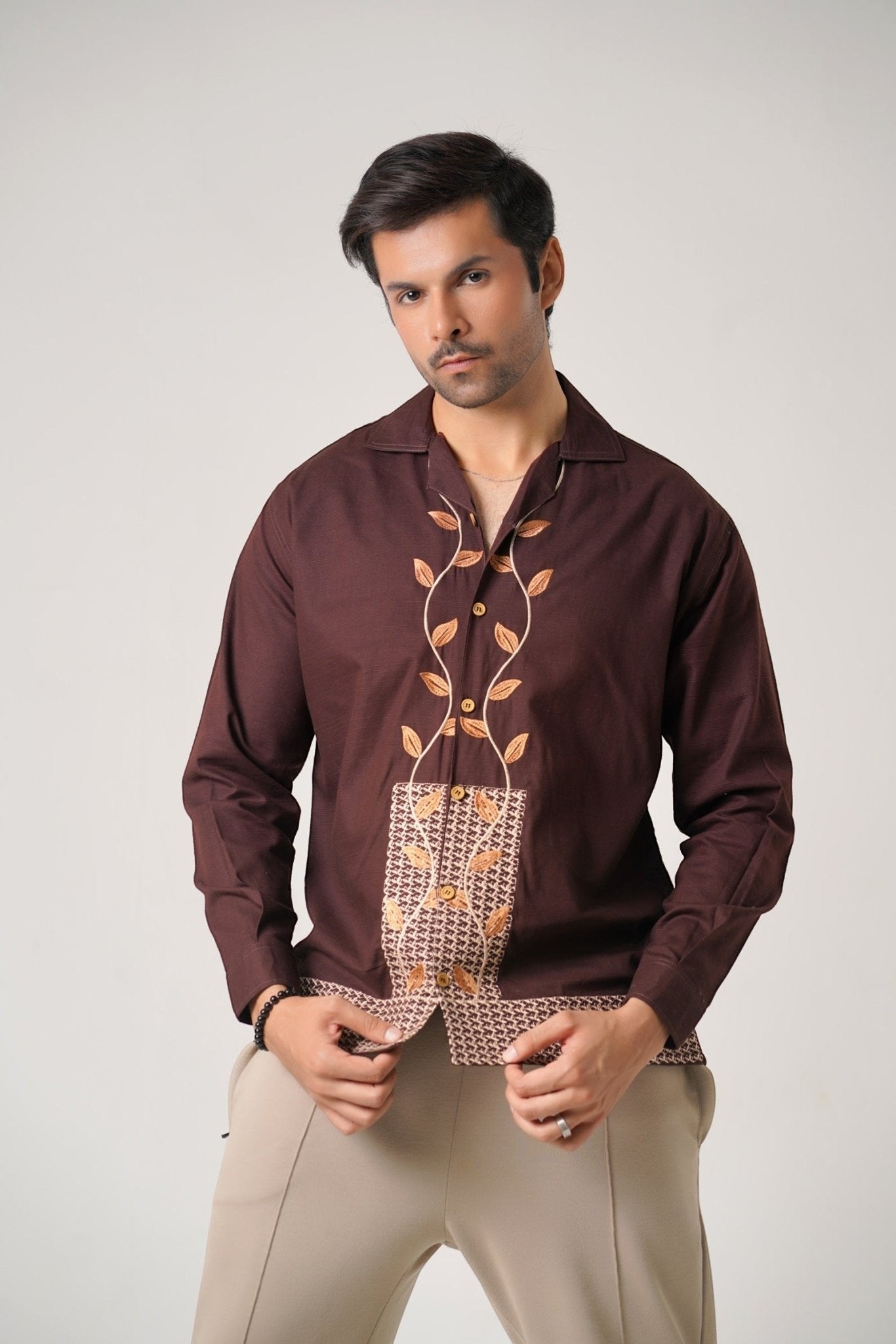 Koti Apparels unisex brown khaddar shirt with leaf embroidery on the front placket and geometric panel. Open collar, button-down, full sleeves.