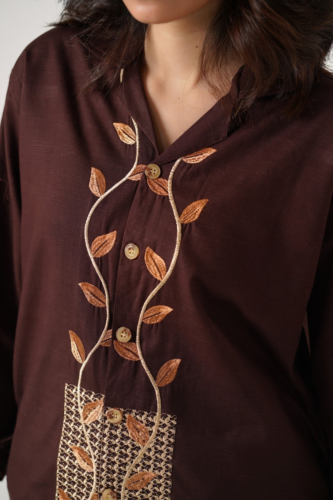 Koti Apparels unisex brown khaddar shirt with leaf embroidery on the placket and cuffs. Features button-down front and open collar.