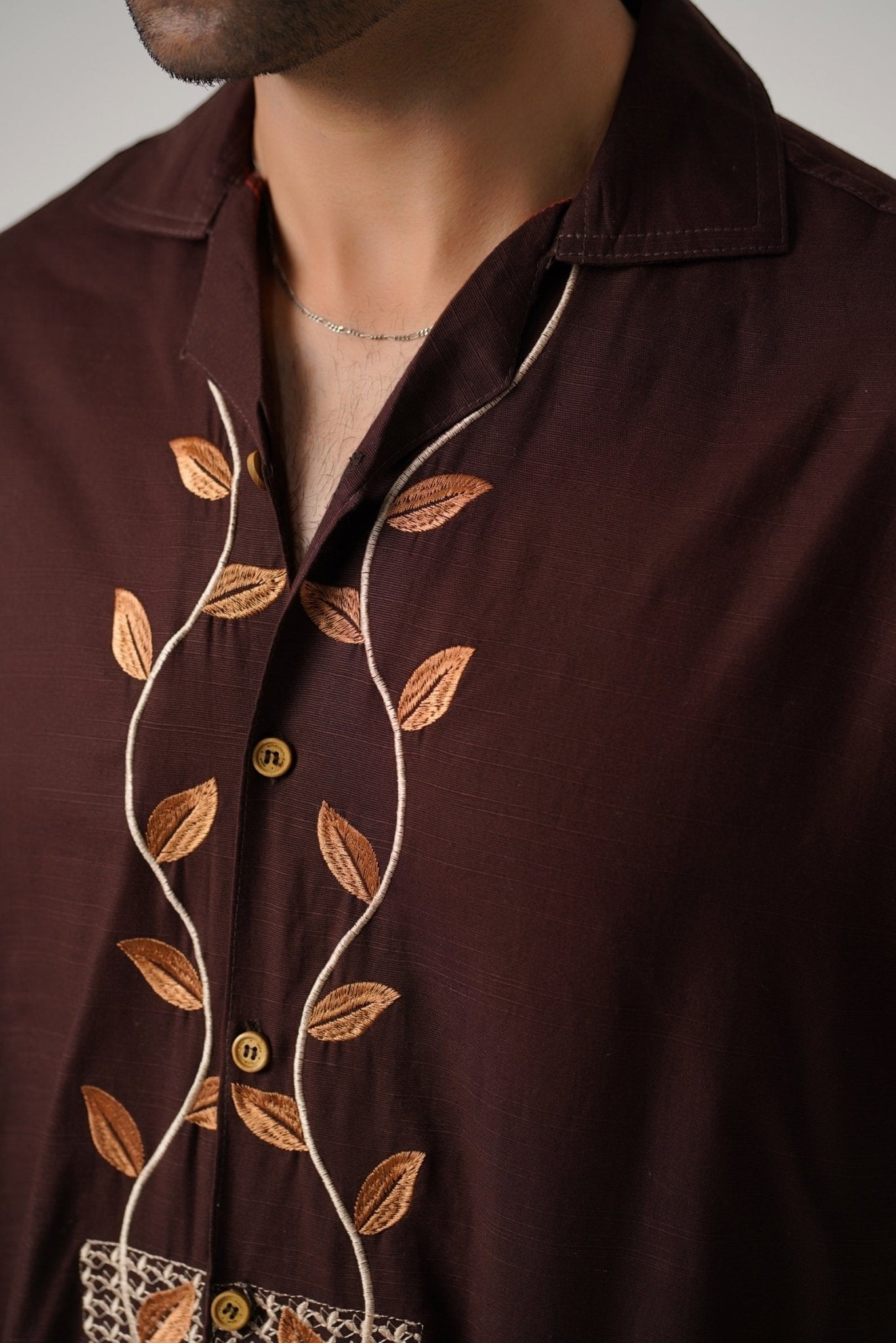 Koti Apparels unisex brown khaddar shirt with leaf embroidery on the placket and open collar.