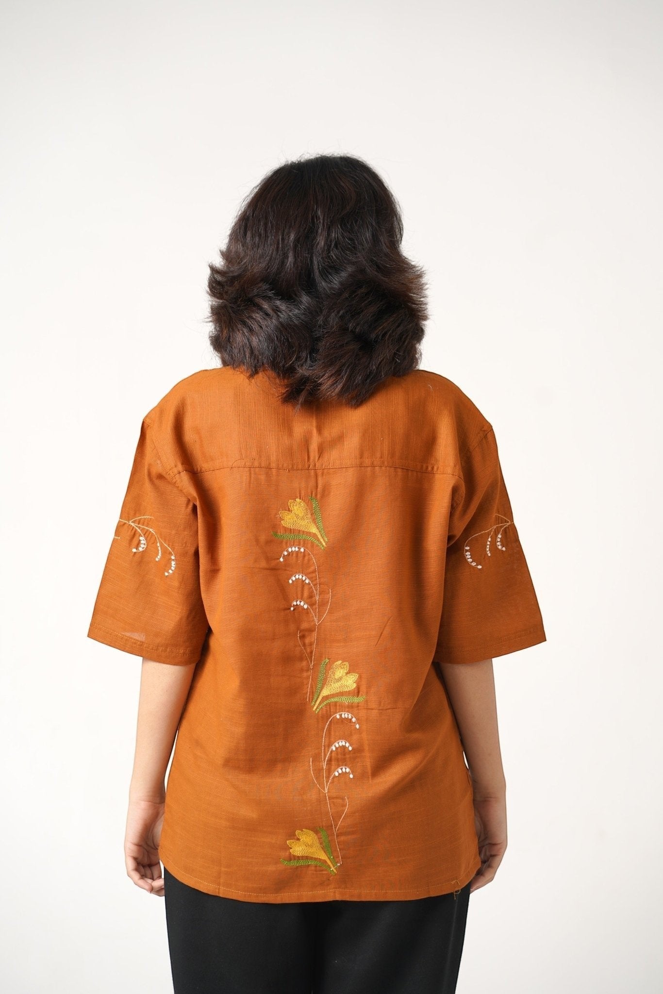 Koti Apparels burnt orange pure dyed khaddar unisex shirt with floral embroidery on the back and sleeves.