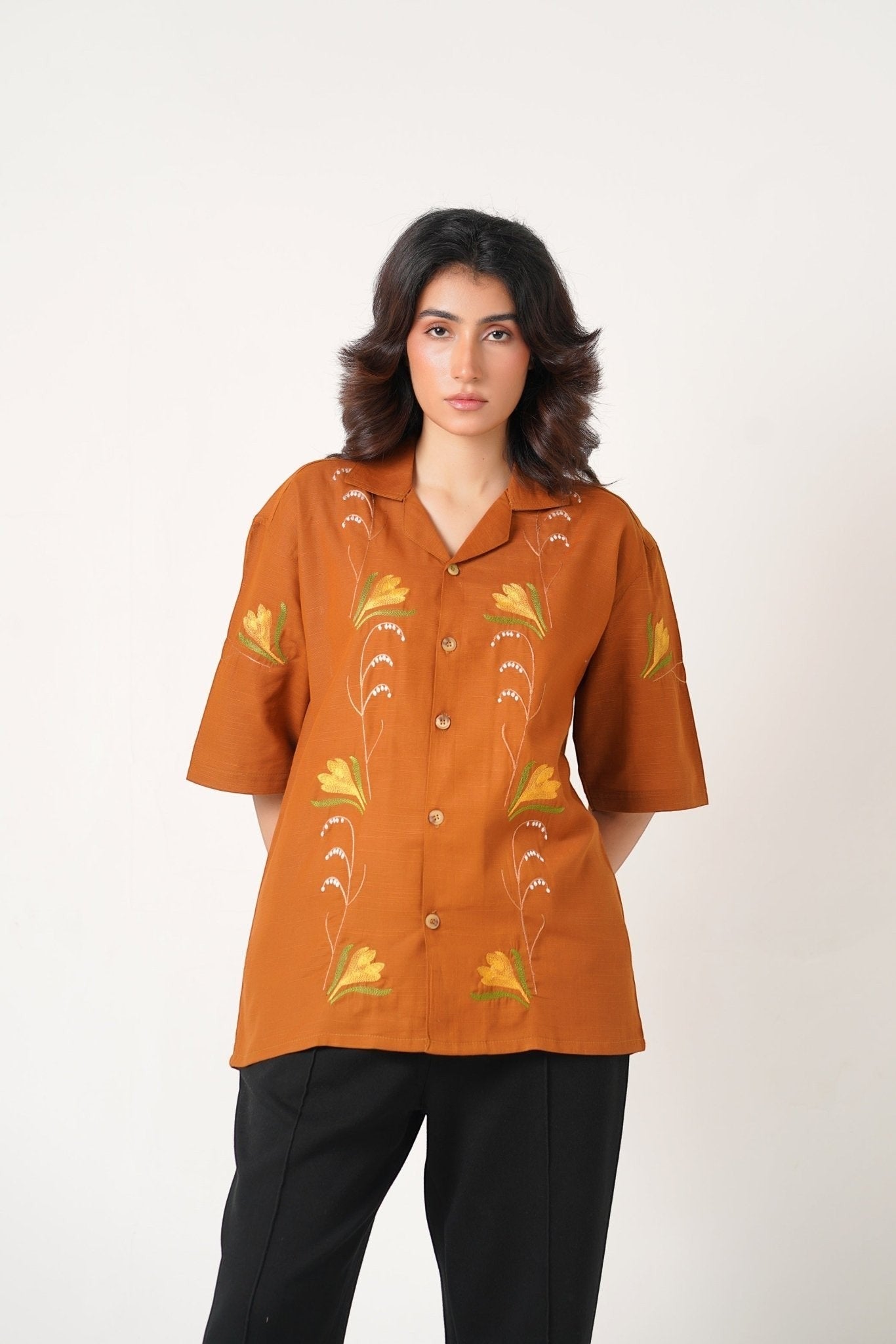 Koti Apparels burnt orange unisex shirt with floral embroidery and wooden buttons. Relaxed fit, half sleeves.