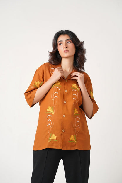 Koti Apparels burnt orange unisex shirt with floral embroidery and wooden buttons. Relaxed fit, half sleeves.
