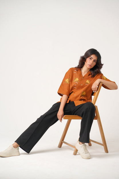 Koti Apparels burnt orange unisex shirt with floral embroidery, wooden buttons, and relaxed fit.