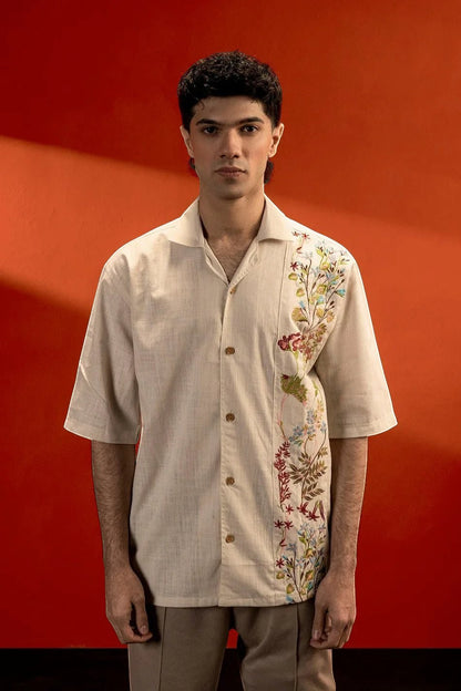Koti Apparels unisex cream cotton jacquard shirt with embroidered floral detail on the left side, half sleeves, and button-down front.