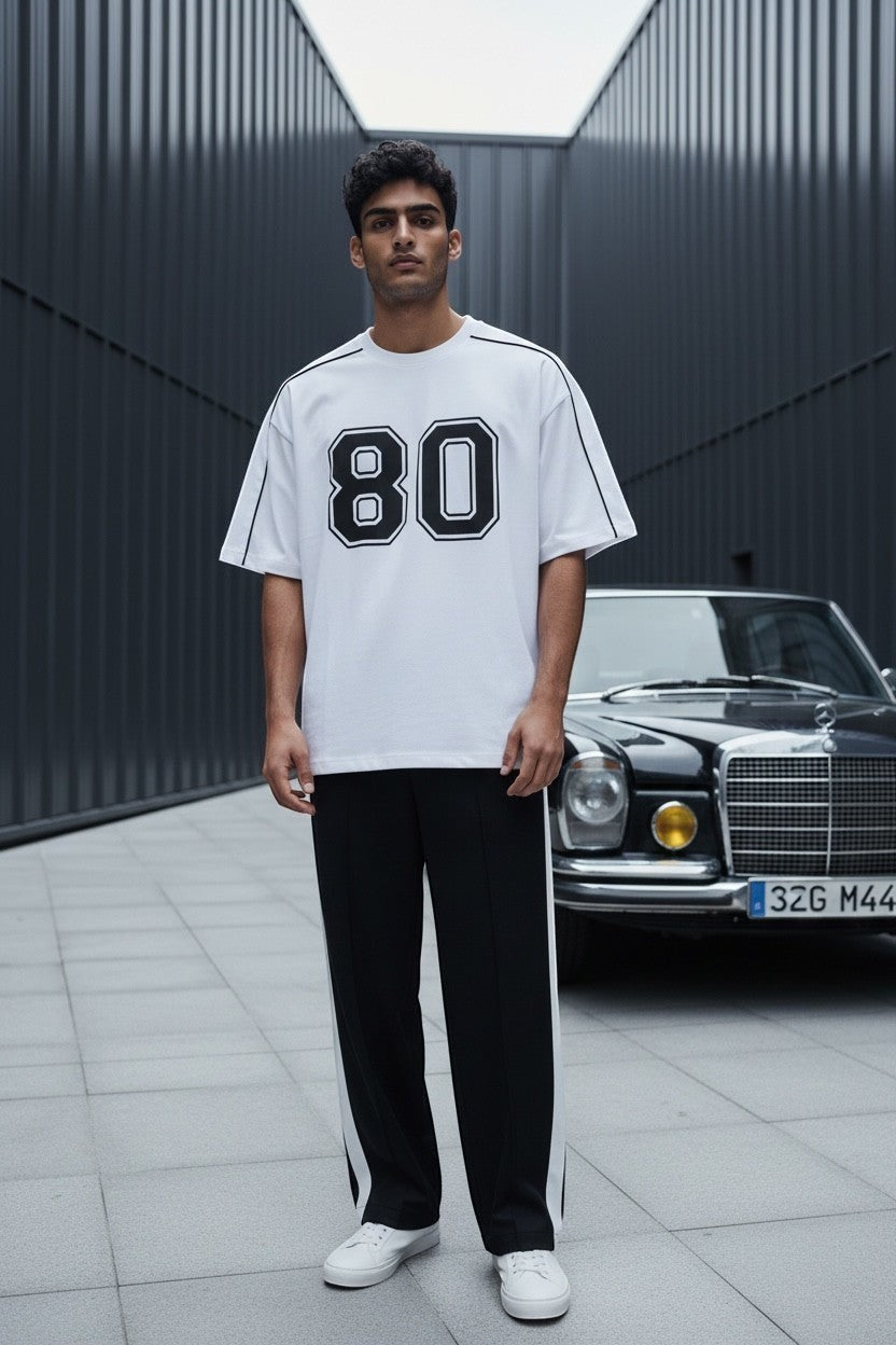 Koti Apparels white cotton blend t-shirt with black "80" graphic and black piping detail.