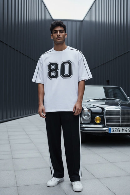 Koti Apparels white cotton blend t-shirt with black "80" graphic and black piping detail.