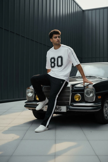 Koti Apparels white cotton blend t-shirt with black "80" graphic and black piping detail.