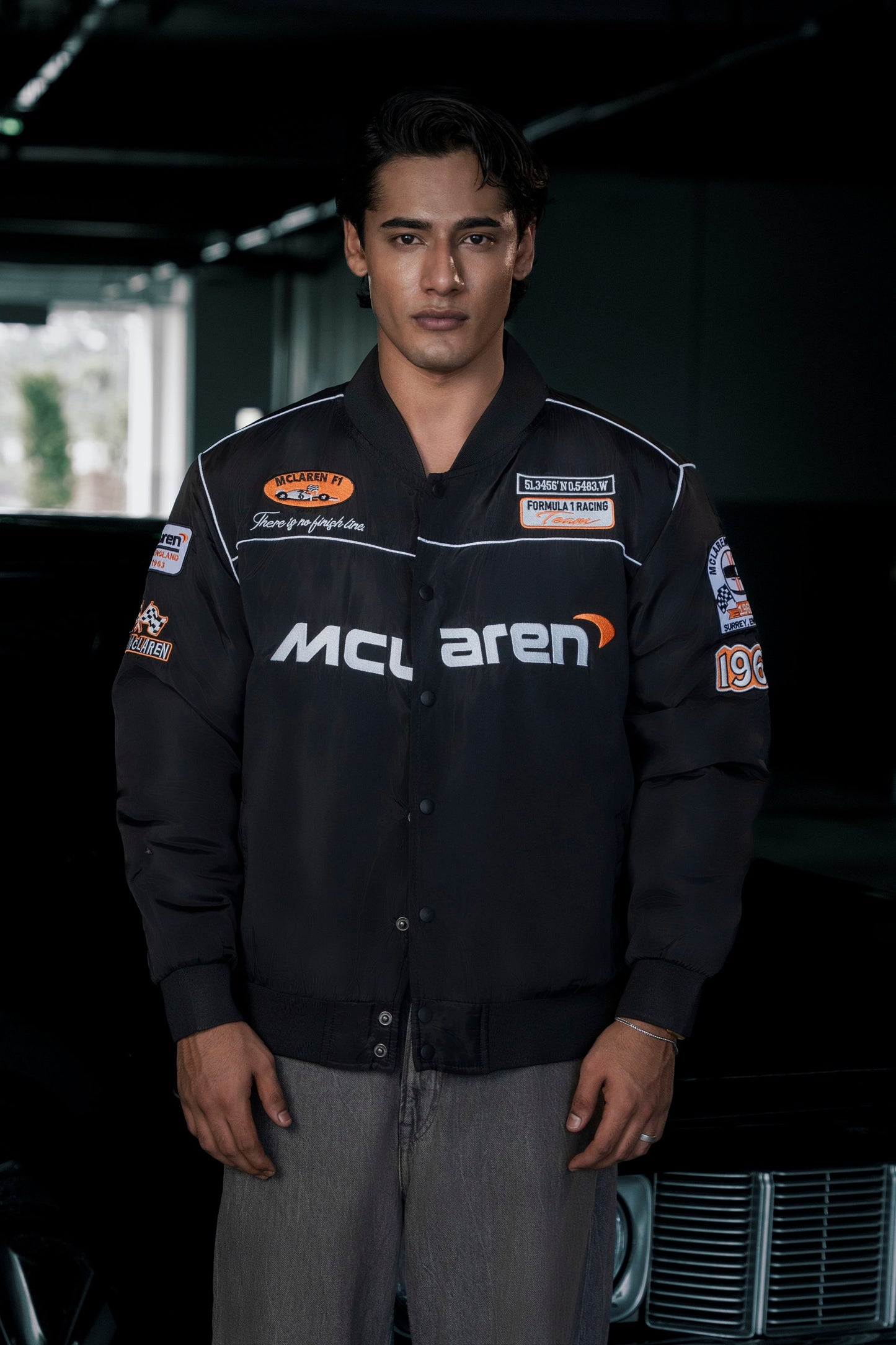 Koti Apparels McLaren F1 jacket in black waterproof parachute fabric with premium embroidered team logos.