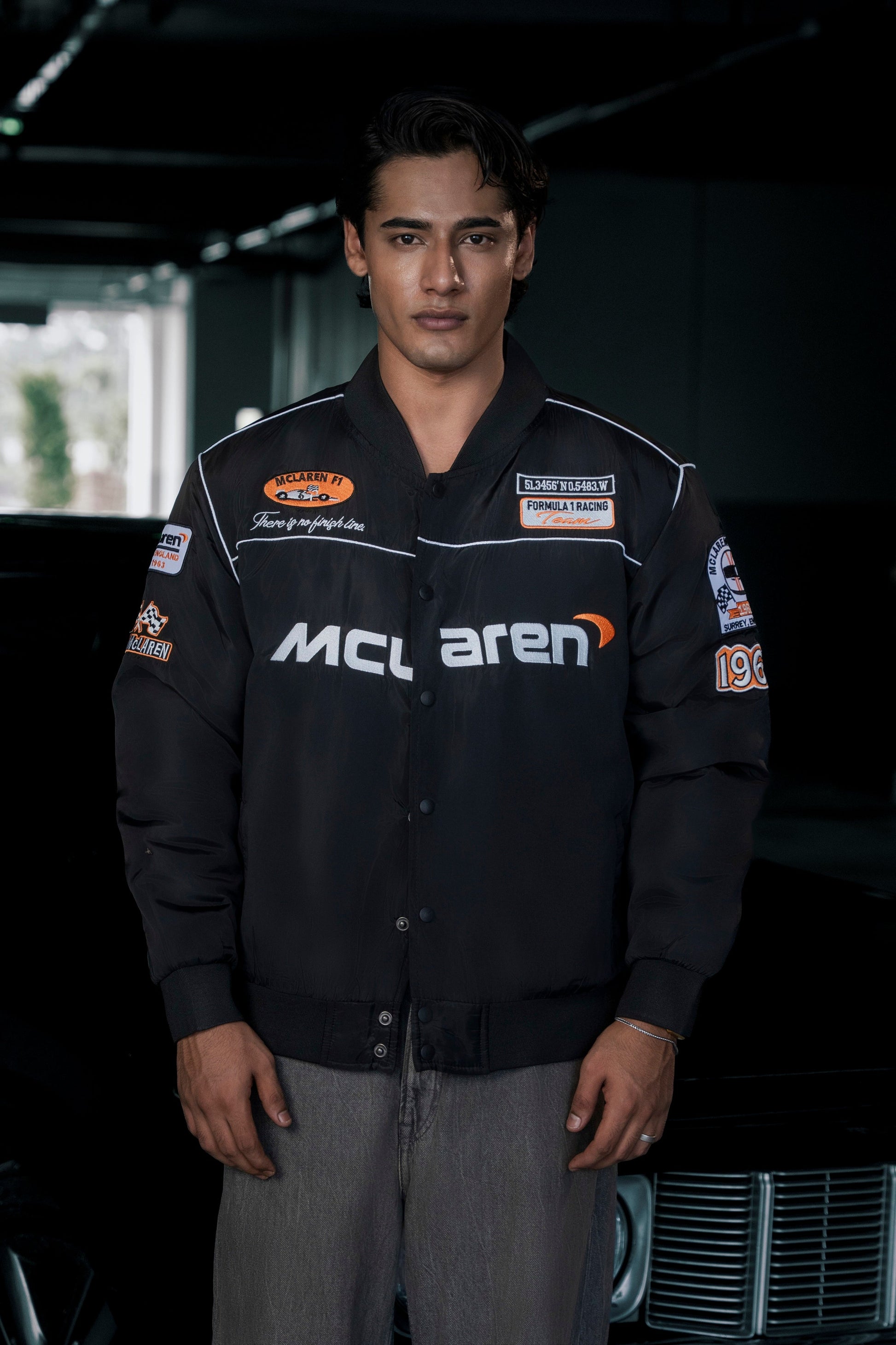 Koti Apparels McLaren F1 jacket in black waterproof parachute fabric with premium embroidered team logos.