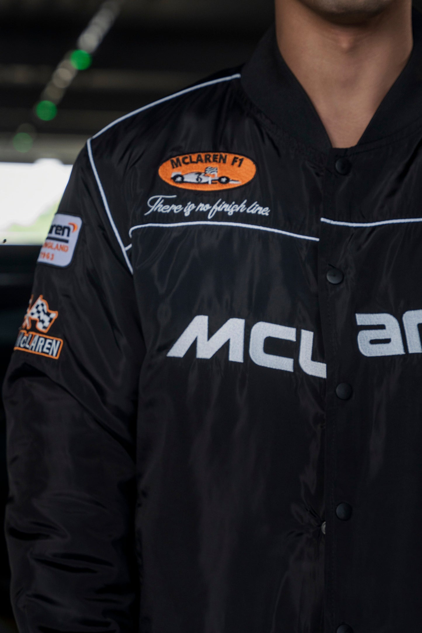Koti Apparels black McLaren F1 racing jacket with premium needle-embroidered logos and full-zip front closure.