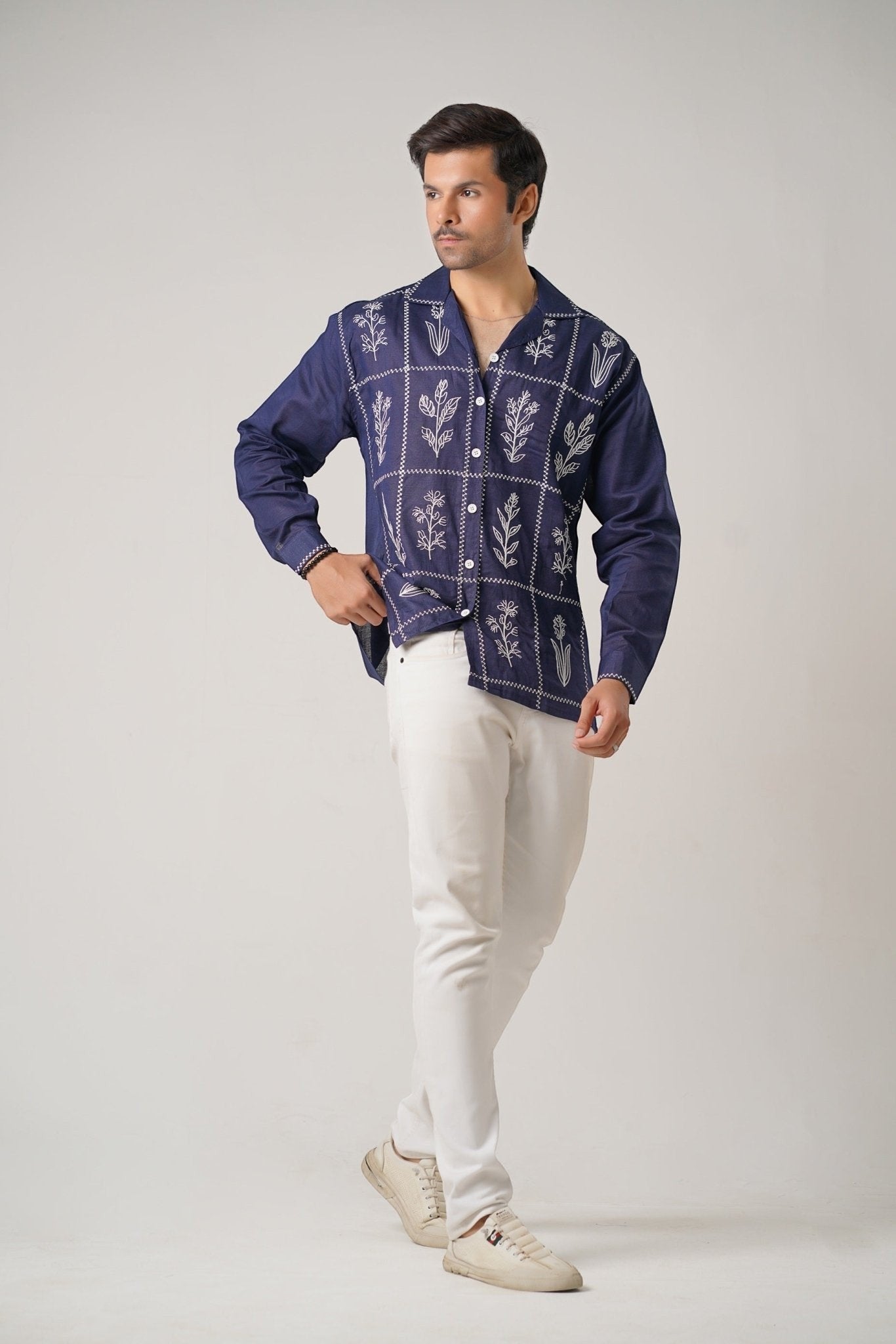 Koti Apparels navy blue cotton khaddar shirt with ivory-white floral embroidery in geometric panels. Unisex, full sleeves, open collar.