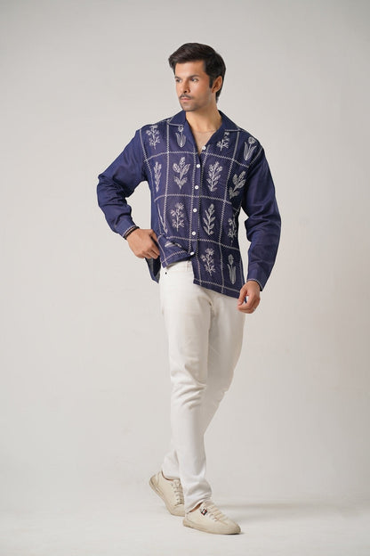Koti Apparels navy blue cotton khaddar shirt with ivory-white floral embroidery in geometric panels. Unisex, full sleeves, open collar.