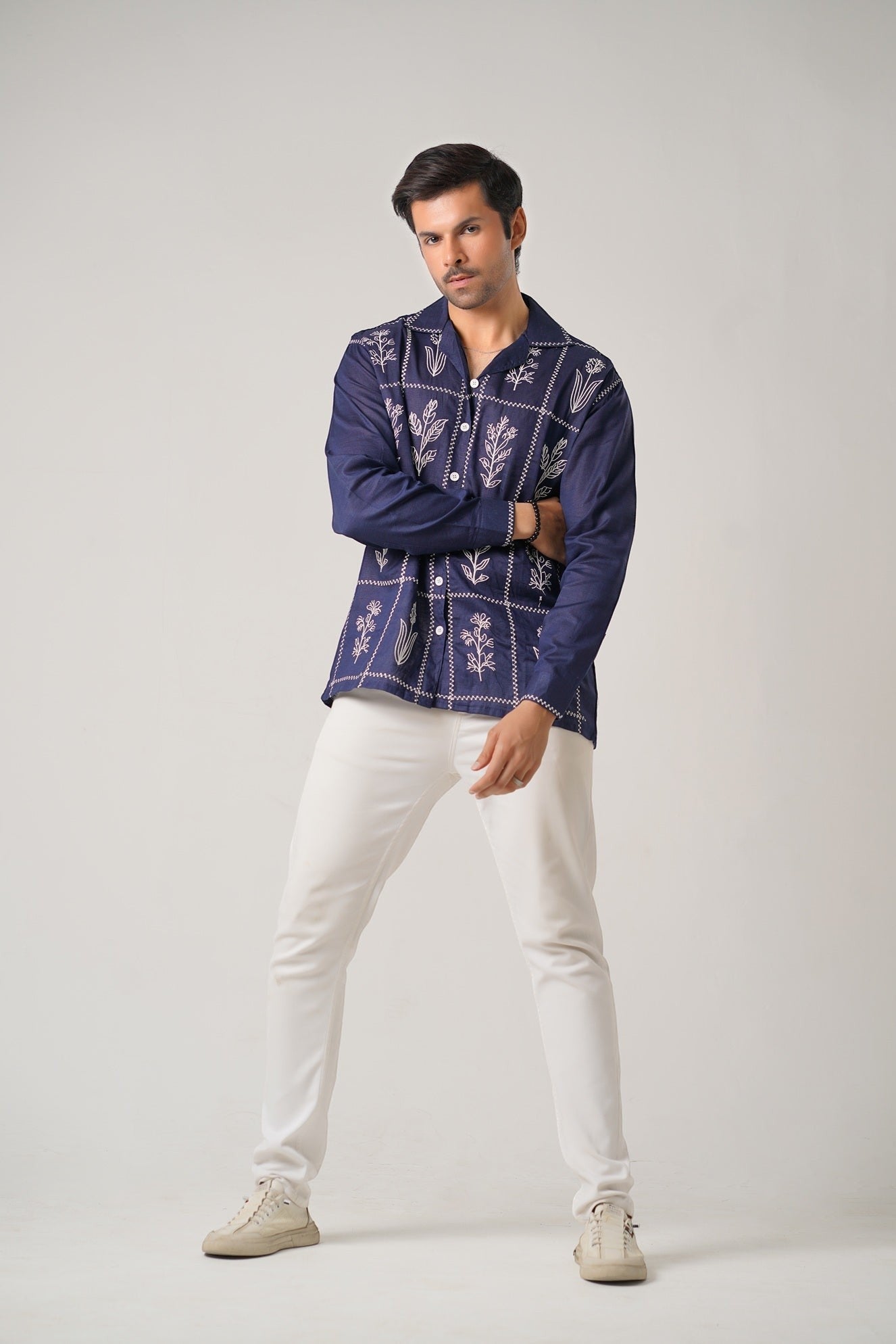 Koti Apparels navy blue cotton khaddar shirt with ivory-white floral embroidery in geometric panels, open collar, button-down front, and full sleeves.
