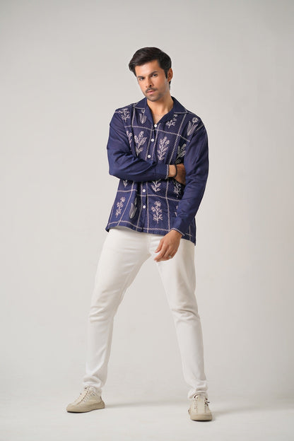Koti Apparels navy blue cotton khaddar shirt with ivory-white floral embroidery in geometric panels, open collar, button-down front, and full sleeves.