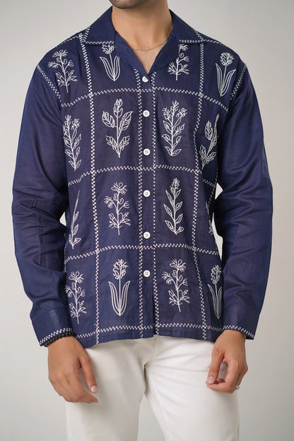 Koti Apparels navy blue cotton khaddar unisex shirt with ivory-white floral embroidery in a grid pattern and open collar.