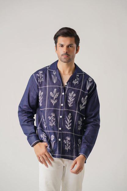Koti Apparels navy blue cotton khaddar unisex shirt with ivory-white floral embroidery in a grid pattern. Open collar, button-down front, full sleeves.