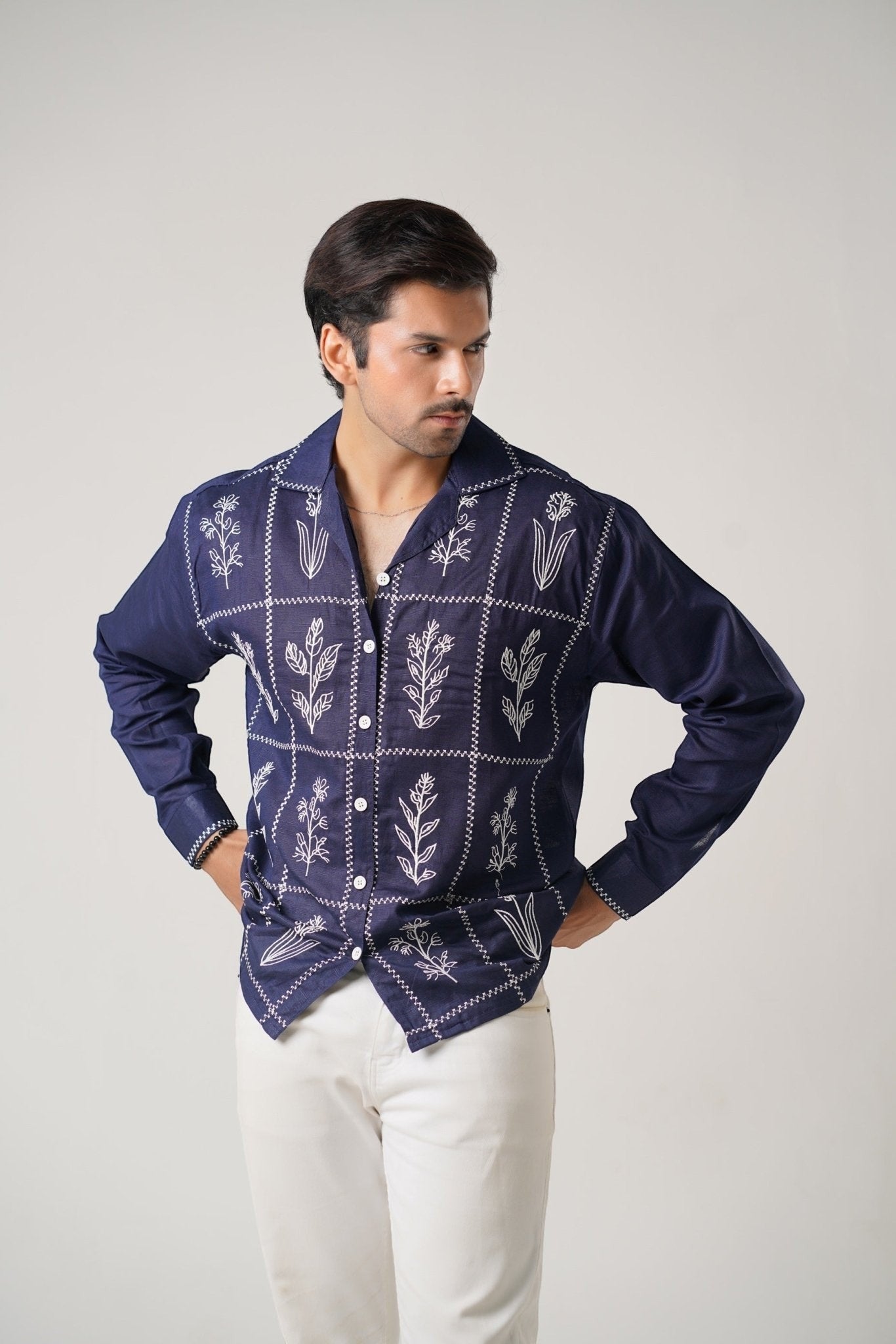 Koti Apparels navy blue cotton khaddar unisex shirt with ivory-white floral embroidery in geometric panels, open collar, and button-down front.