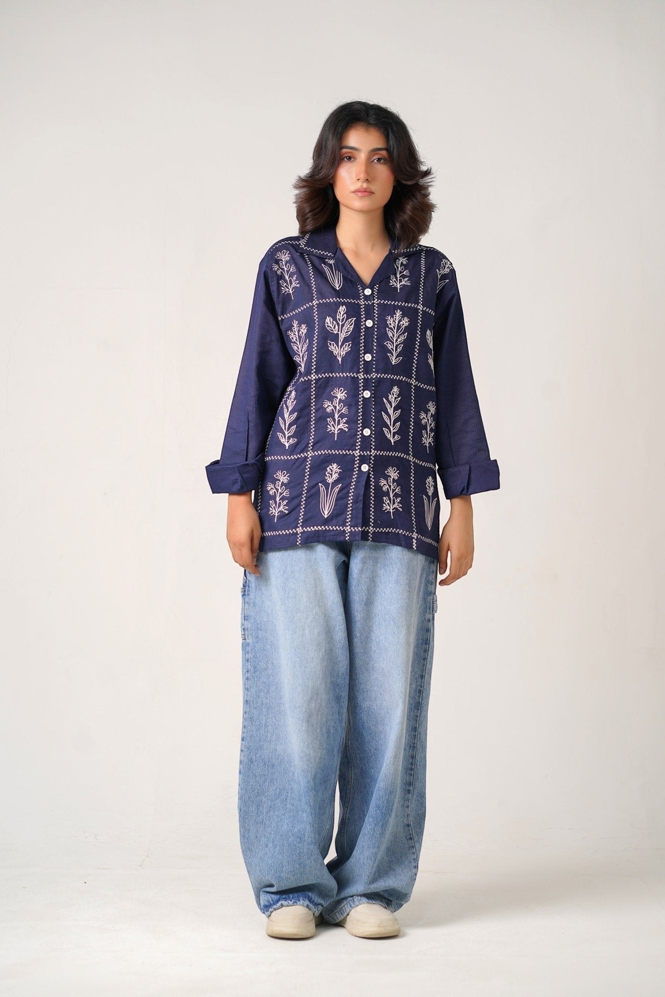 Koti Apparels navy blue cotton khaddar unisex shirt with ivory-white floral embroidery in geometric panels, open collar, button-down front.