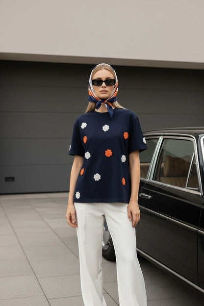 Koti Apparels navy blue t-shirt with short sleeves and crew neck, featuring embroidered floral appliques in orange and white.