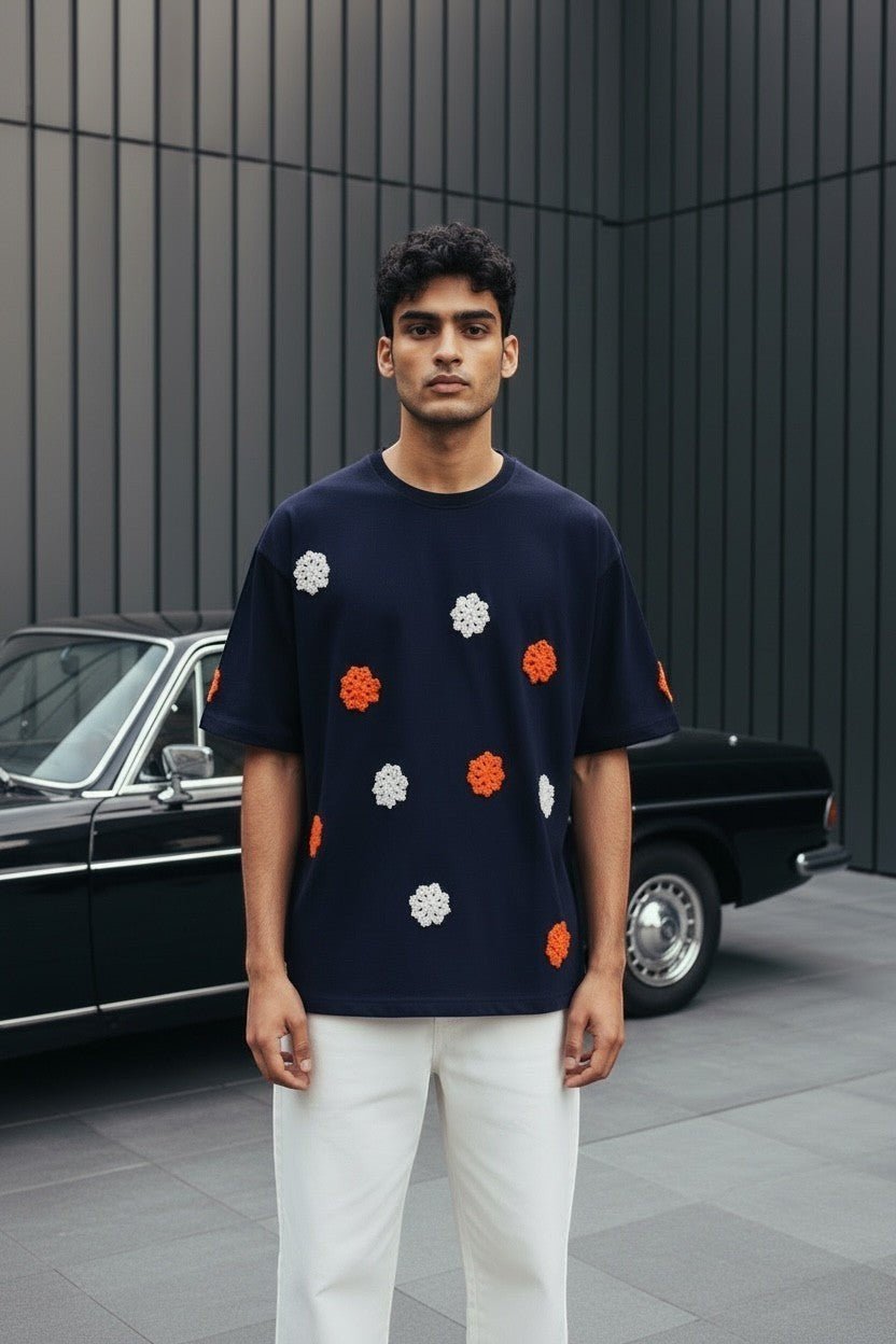 Koti Apparels navy blue t-shirt with short sleeves and crew neck, featuring embroidered floral appliques in orange and white.