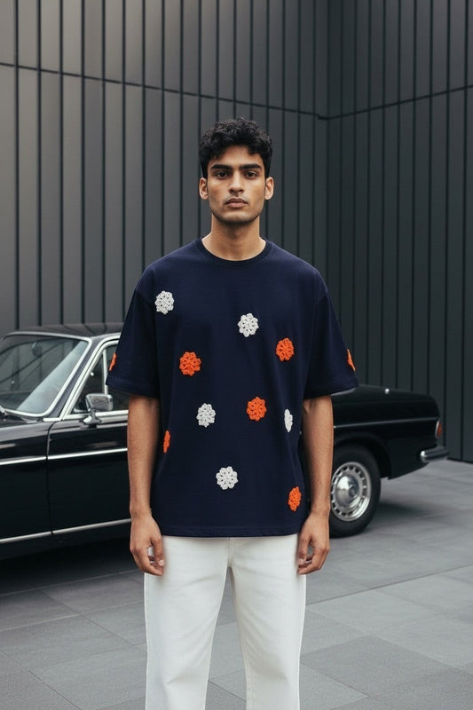 Koti Apparels navy blue t-shirt with short sleeves and crew neck, featuring embroidered floral appliques in orange and white.
