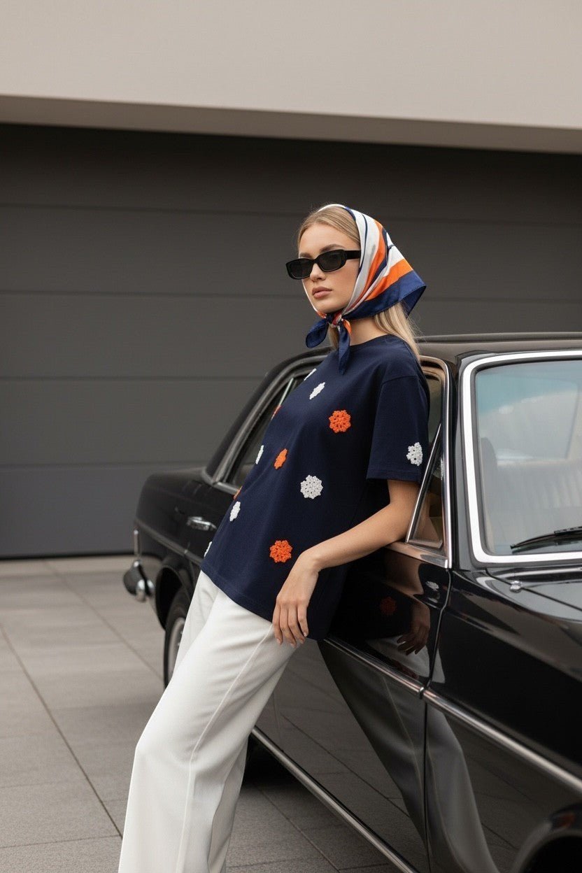 Koti Apparels navy blue t-shirt with embroidered orange and white floral appliques, short sleeves, crew neck.