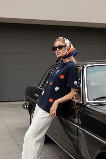 Koti Apparels navy blue t-shirt with embroidered orange and white floral appliques, short sleeves, crew neck.