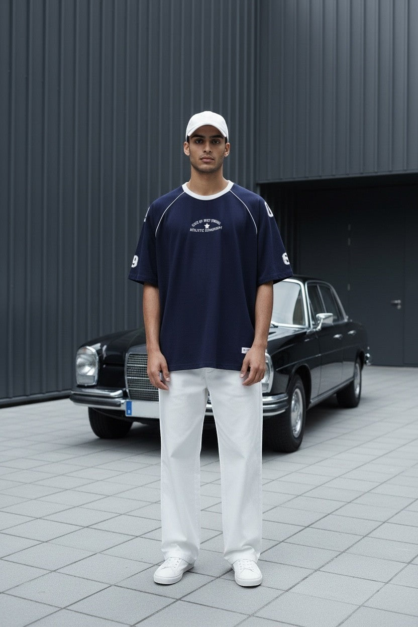 Koti Apparels navy blue cotton graphic t-shirt with white piping on raglan sleeves and oversized fit.