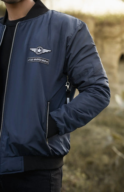 Koti Apparels navy blue reversible bomber jacket with embroidered patches and ribbed cuffs.