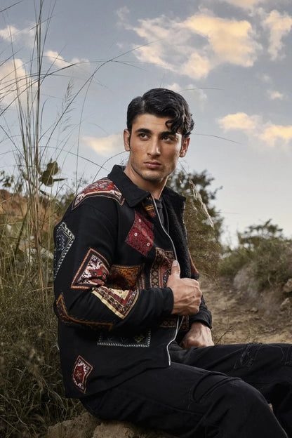 Koti Apparels men's black canvas jacket with multicolour patchwork panels, zipper closure, and side pockets.