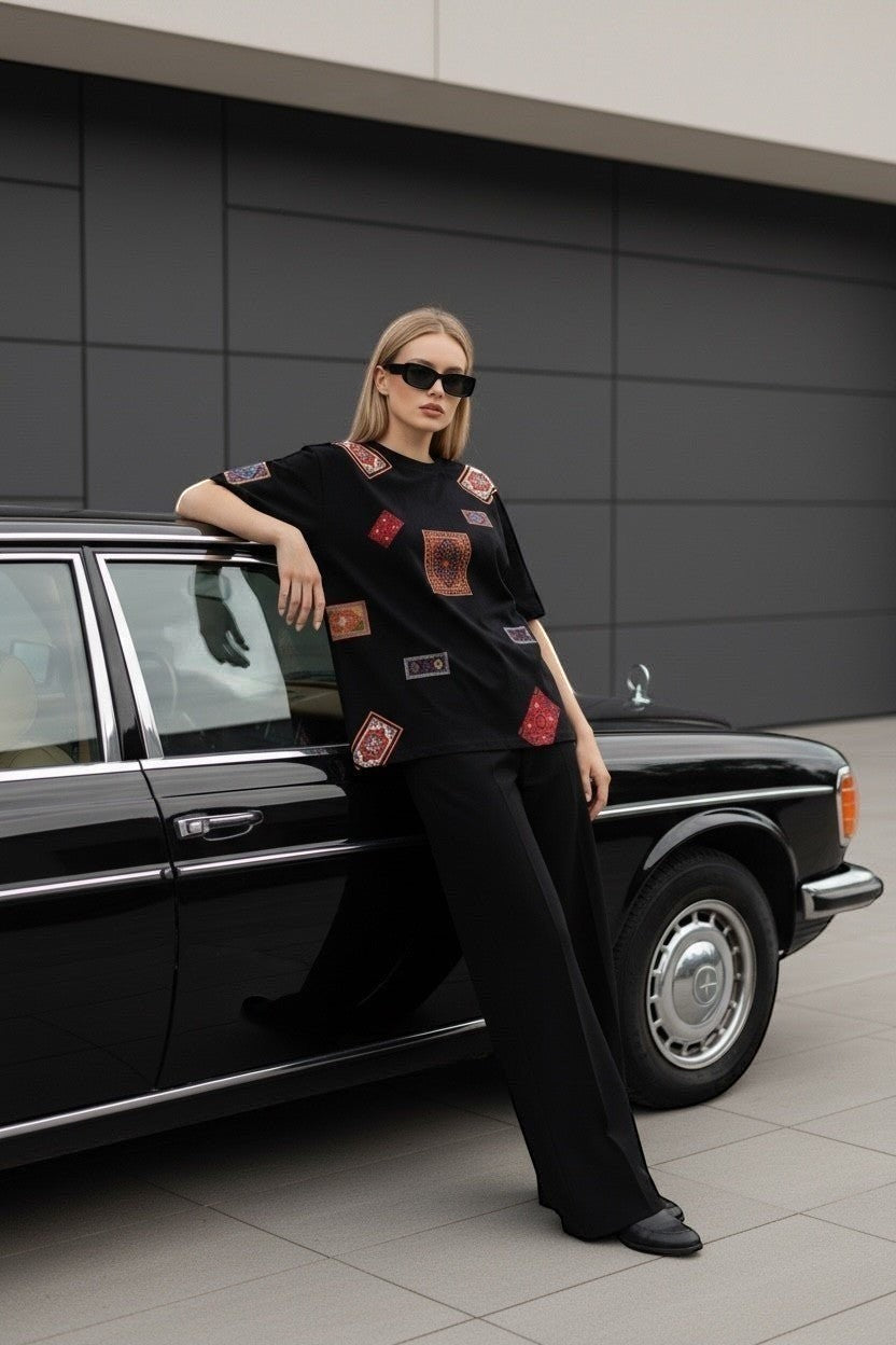 Koti Apparels black cotton t-shirt with colorful oriental rug patches, relaxed fit, crew neck.