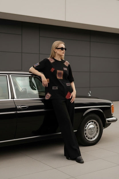 Koti Apparels black cotton t-shirt with colorful oriental rug patches, relaxed fit, short sleeves.