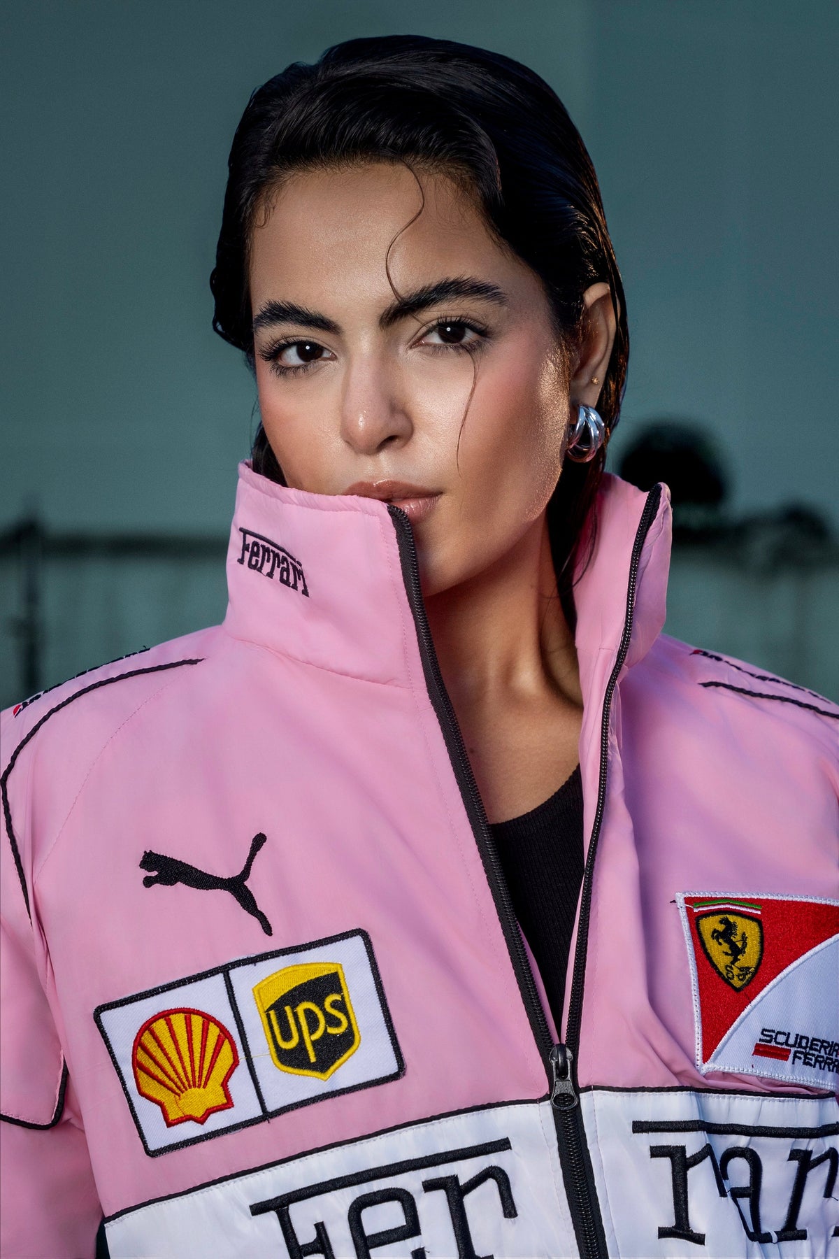 Koti Apparels pink Ferrari racing jacket with embroidered sponsor logos worn by a model with a high collar