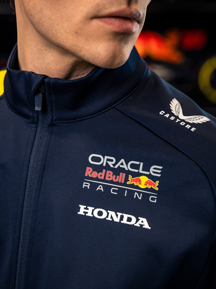 Koti Apparels navy blue polyester Formula 1 racing jacket with Red Bull Racing, Honda, and Castore logos. Full zip and zipped pockets.