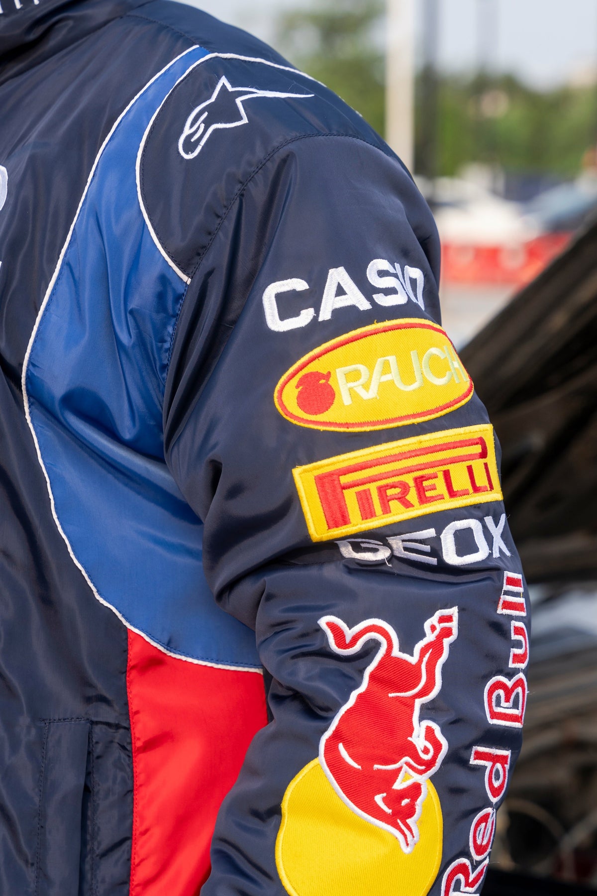 Koti Apparels Red Bull racing jacket sleeve featuring authentic embroidered team logos and bold blue and red panels