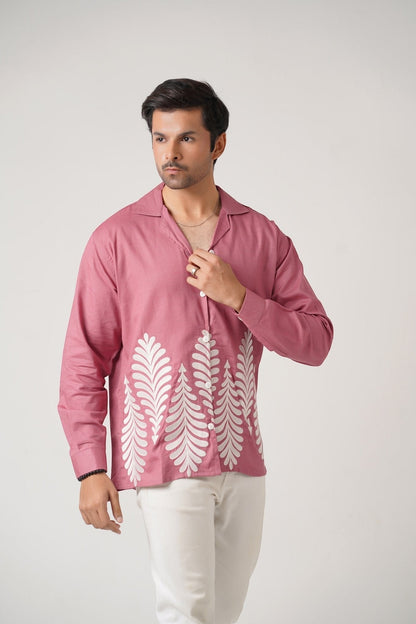 Koti Apparels rose pink unisex shirt with full sleeves, button-down front, and white leaf embroidery on the hem. Model wears size L.