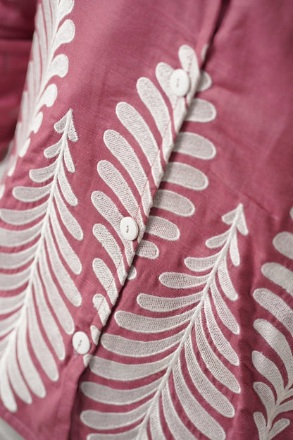 Koti Apparels rose pink unisex shirt with white leaf embroidery on the hem and button-down front.
