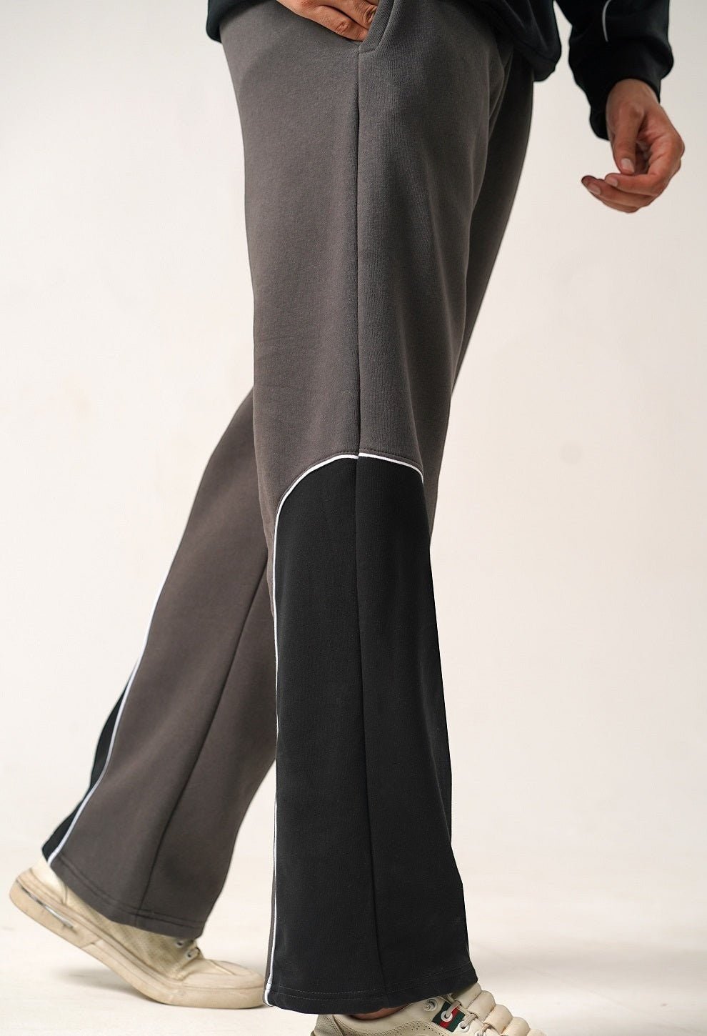 Koti Apparels heavyweight unisex winter fleece trousers in charcoal grey with black side panels and white piping.